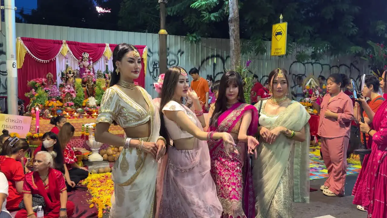 Thai devotees wearing Indian sari posing for photos during the Navaratri Festival in Bangkok Thailand