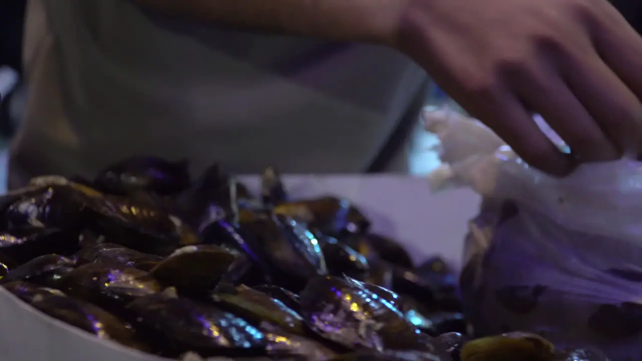 Closeup of Hands Preparing Stuffed Mussels on Turkish Market in Istanbul