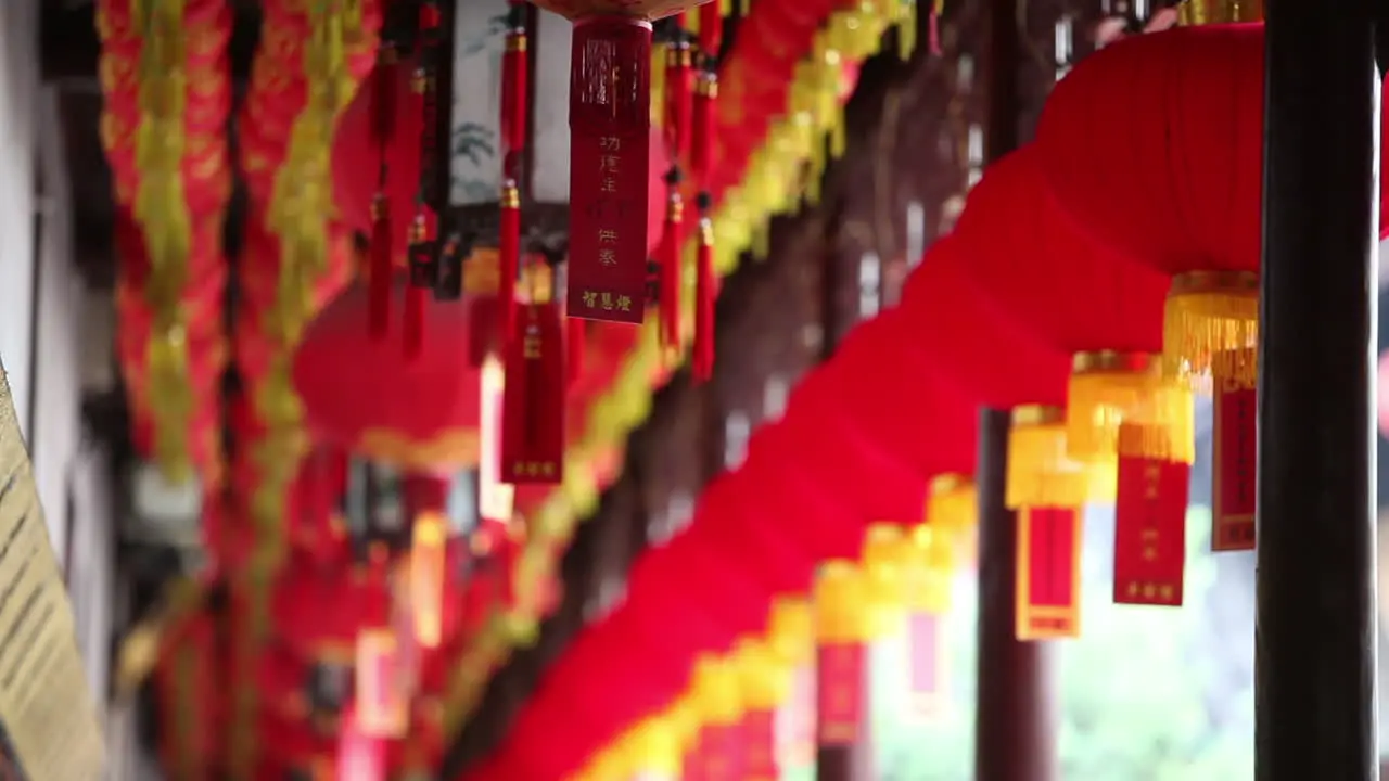 Lanterns and tassels hang from the rafters in a Buddhist temple in China