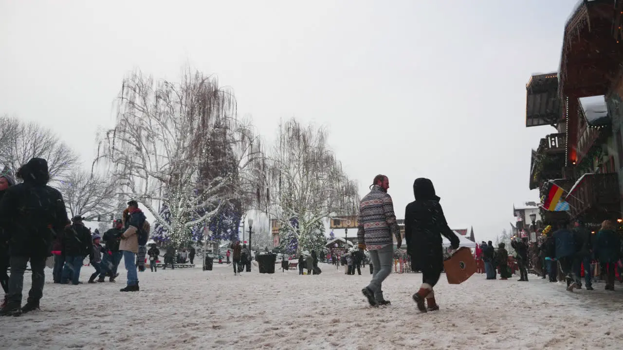 Static shot of People walking on a road covered with snow on a winter morning in Leavenworth WA