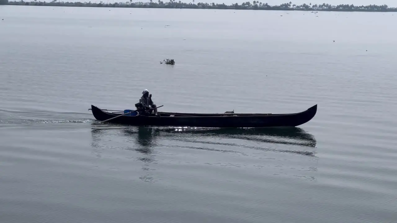 Aerial drone view A brother is carrying a bottle in the middle of the water where there are waves in the water