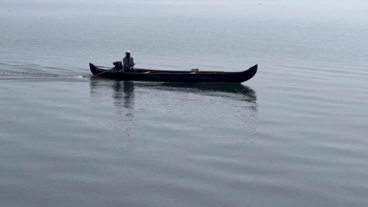 Aerial drone view A brother is carrying a bottle in the middle of the sea