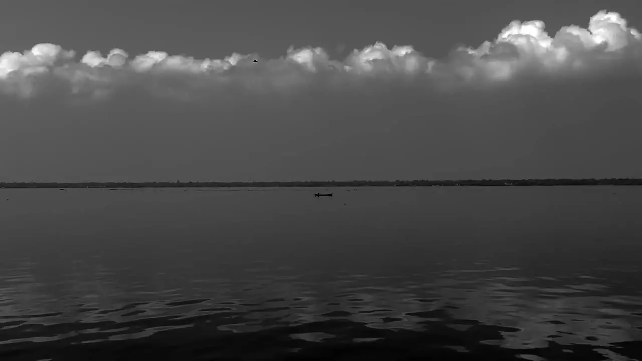 AERIAL DRONE VIEW The drone is moving towards the camera where there is a boat going in the middle of the water