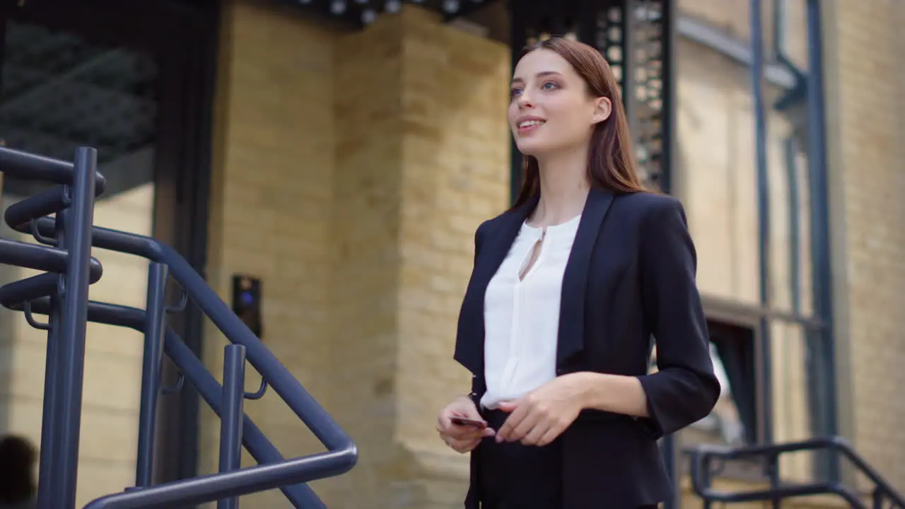 Lady taking order from courier outdoors Business woman paying delivery man card