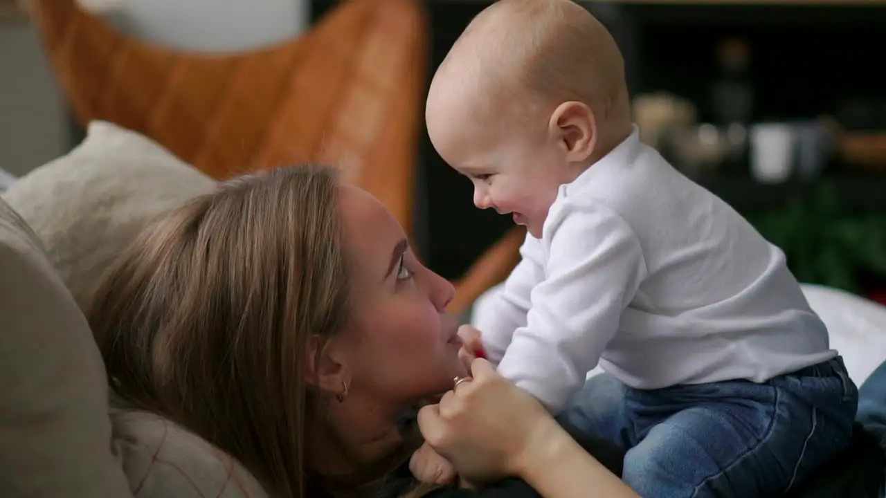 The best moments from life a loving happy young mother hugs a nursing son on a snow-white blanket on a white background concept of love family and happiness Concept children kids baby babies