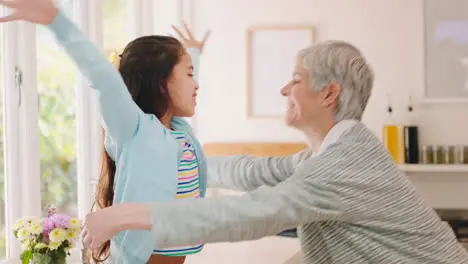 Happy family and girl hug grandmother in kitchen