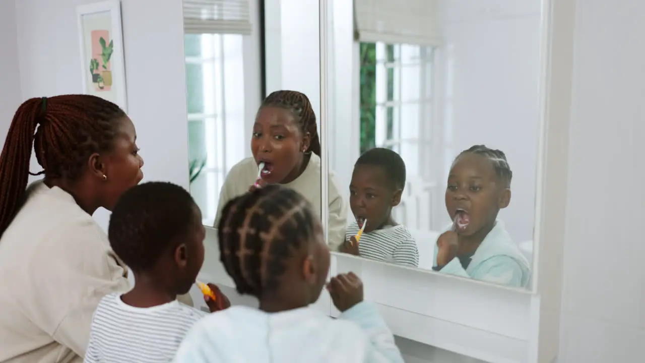 African mother children and brushing teeth