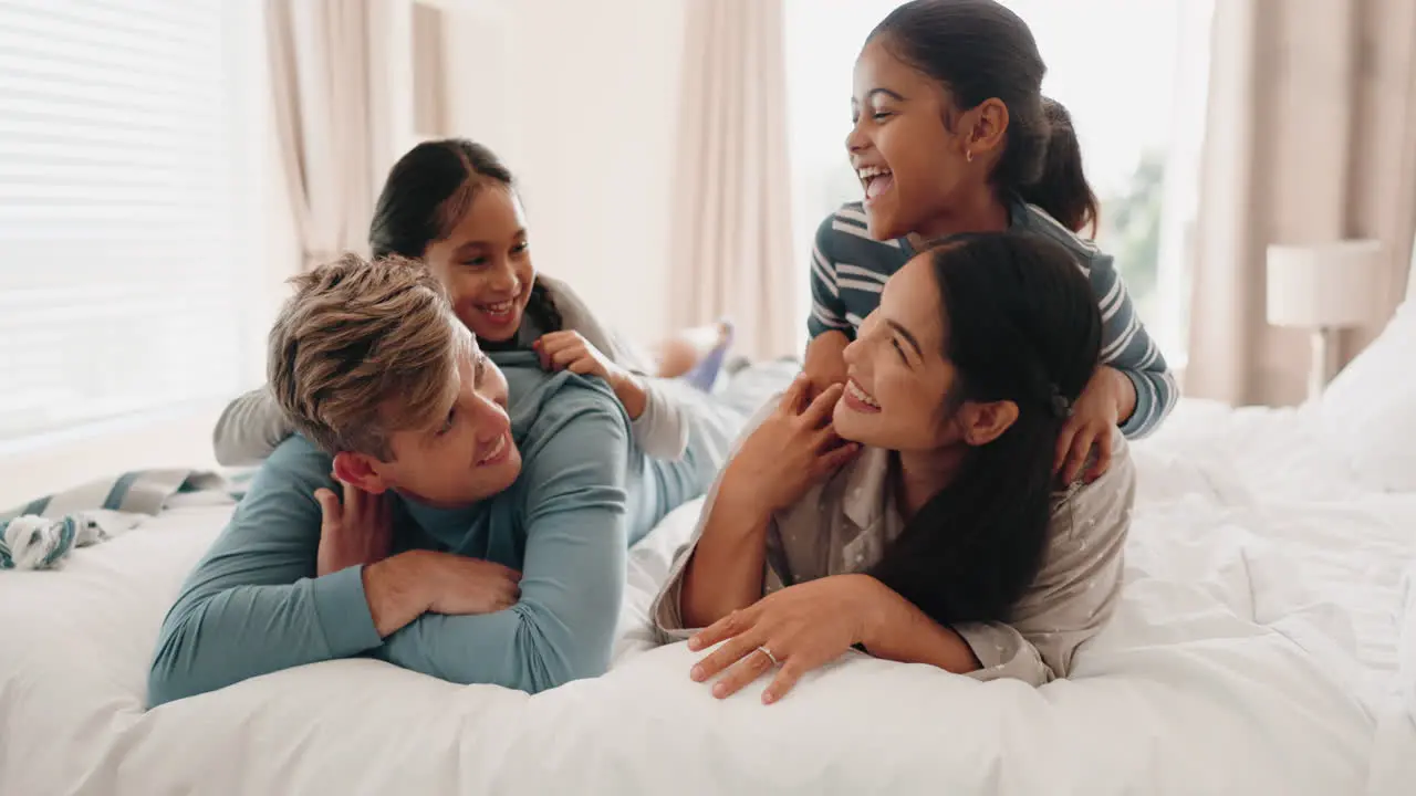 Morning bed and happy family playing in bedroom