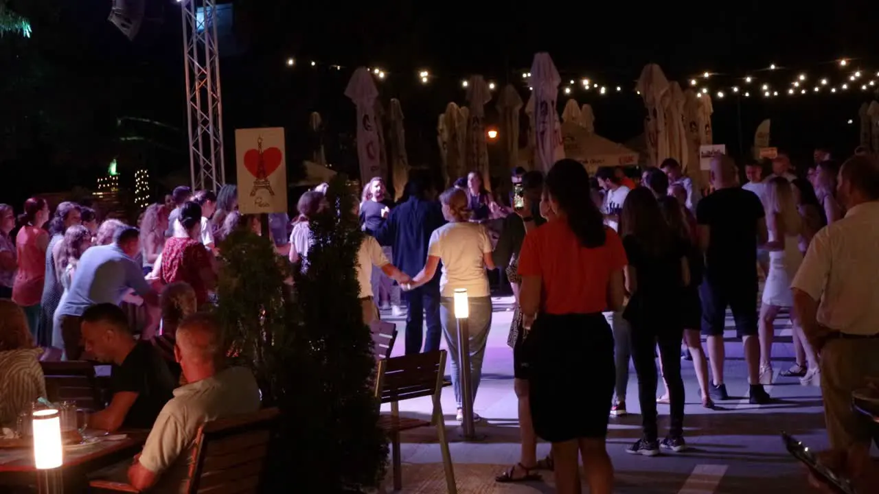 People Group Dancing in Romania Bucharest Evening