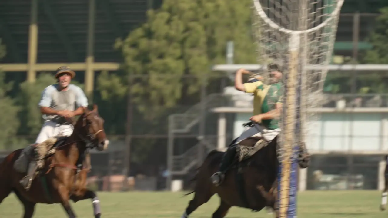 Rider on horseback throws leather ball into netted hoop traditional Pato