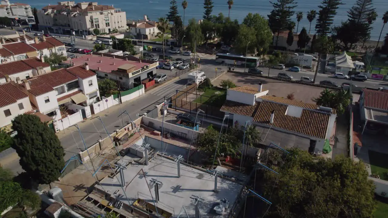 The crossroad in the city with vehicles passing along the sea