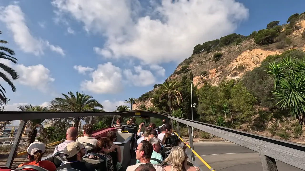 Pov of street view on a city tour around the city of Barcelona by bus Spain