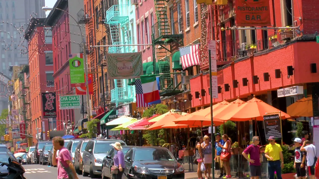 Street scene in Little Italy Manhattan people walking and crossing roads with traffic