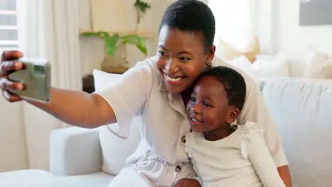 Smartphone selfie and mother with child on living