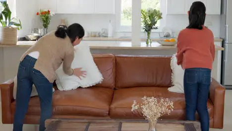 Asian family mom and girl cleaning living room