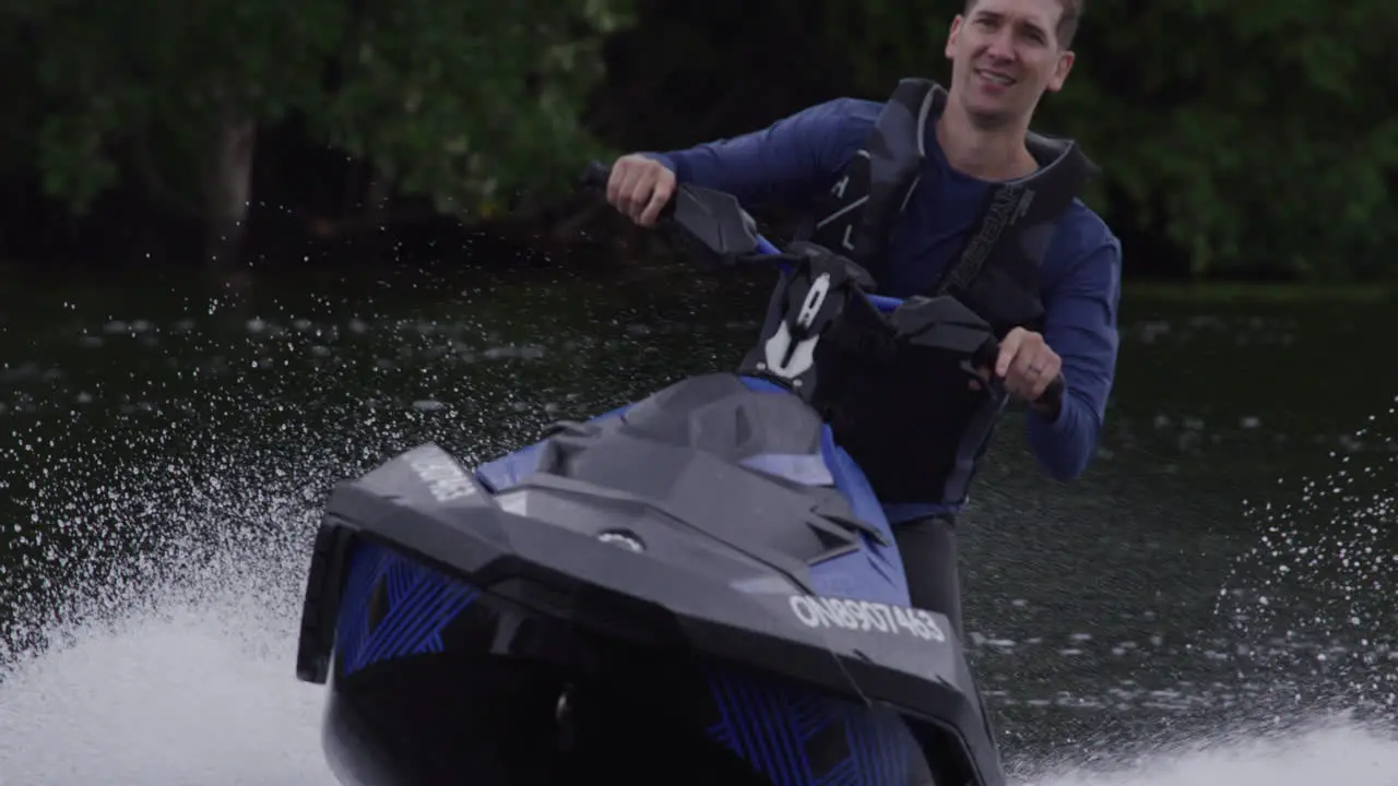 caucasian dad having fun on a jet ski summer vacation