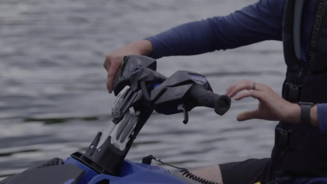 Close up hands on a jet ski handlebar