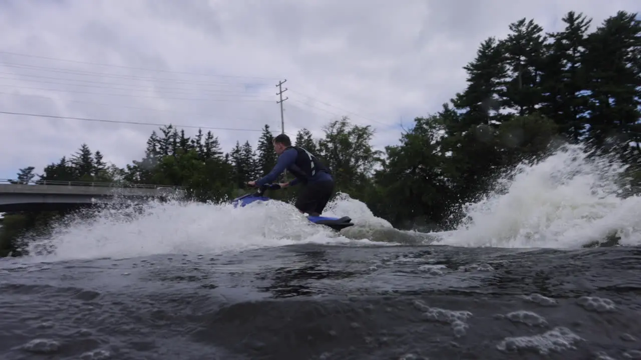 Jet ski rider doing a wheelie on a modern trick rig