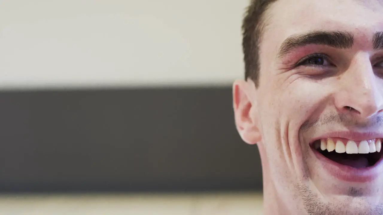 Half portrait of male caucasian basketball player in indoor court in slow motion