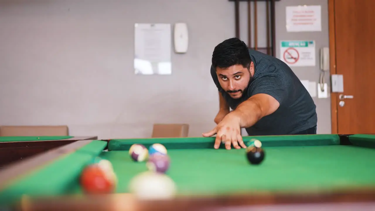 Young man playing billiard snooker player missing the shot