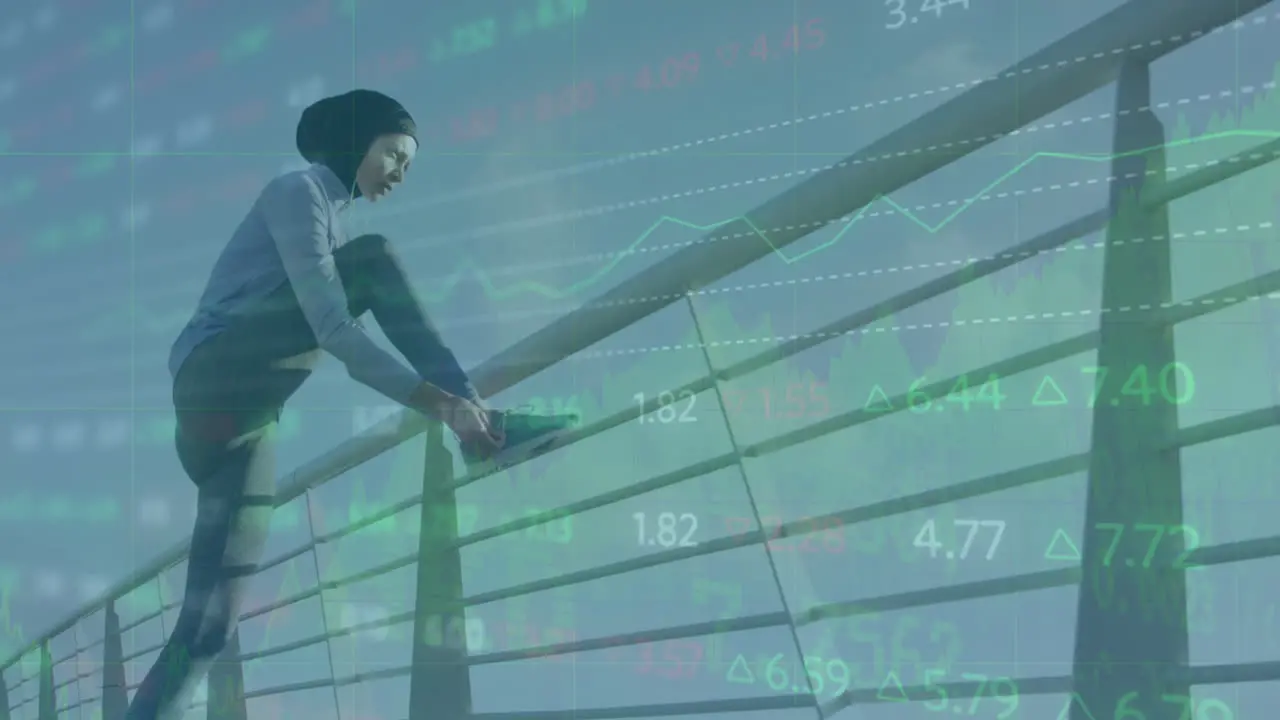 Animation of stock market data processing over biracial woman in hijab tying shoe laces on bridge