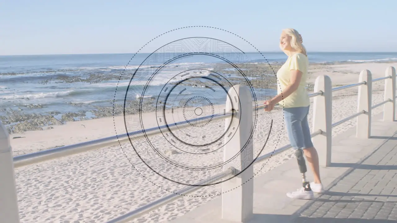 Round scanner against caucasian senior woman with prosthetic leg standing on the promenade