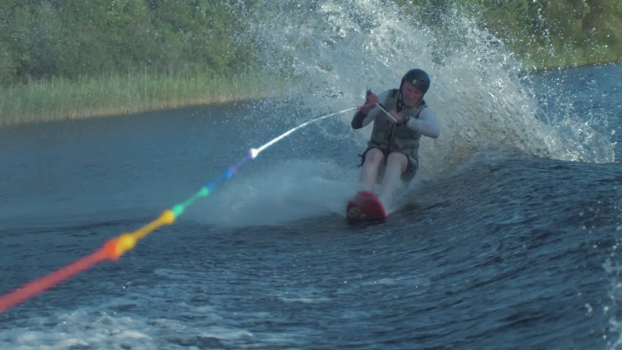 Man jumps boat wake on skyski air chair