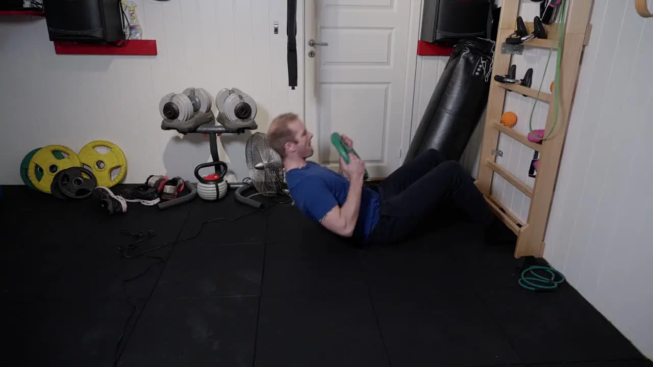 Weighted Rib Wall Sit-Ups Intense Ab Training for man in home gym