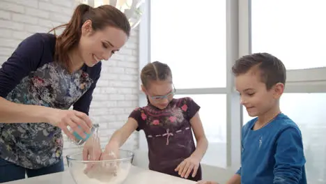 Cooking family have fun on kitchen Woman cooking cake with childrens