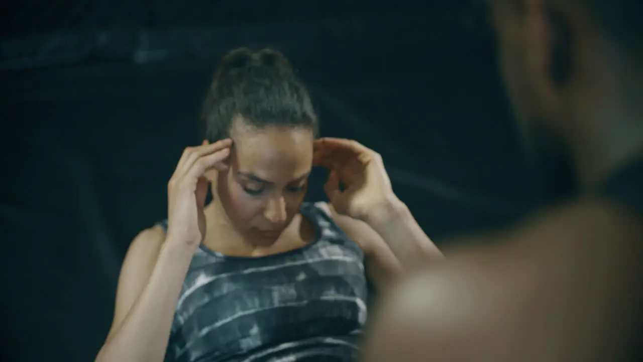 Lady Doing Sit Ups With Personal Trainer