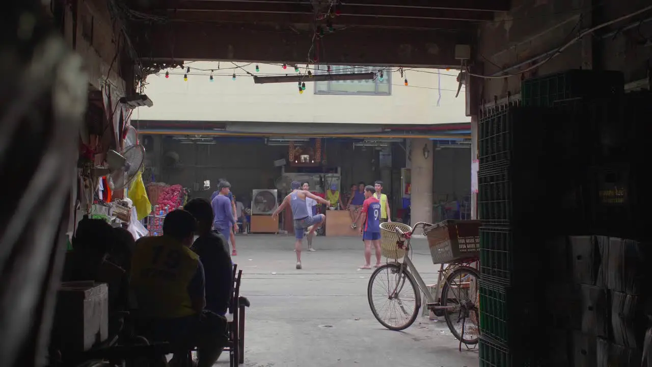 Men Playing With Football in Bangkok