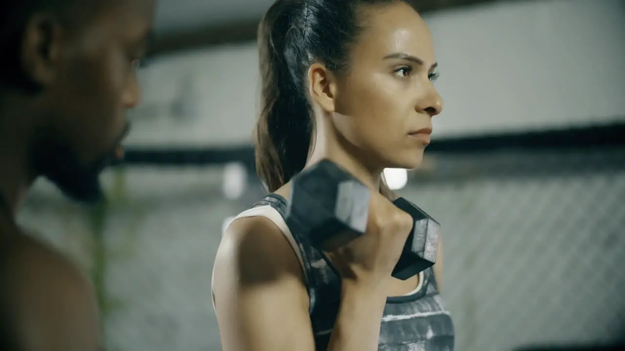 Woman Working with Personal Trainer in Gym