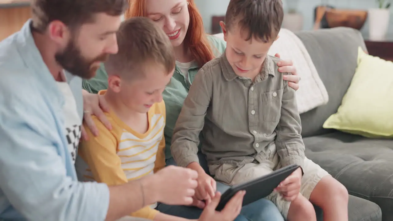 Parents children and tablet in family home