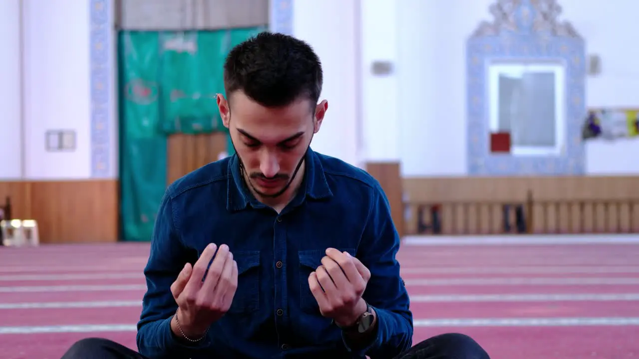 Man Raising His Hands And Praying In A Mosque