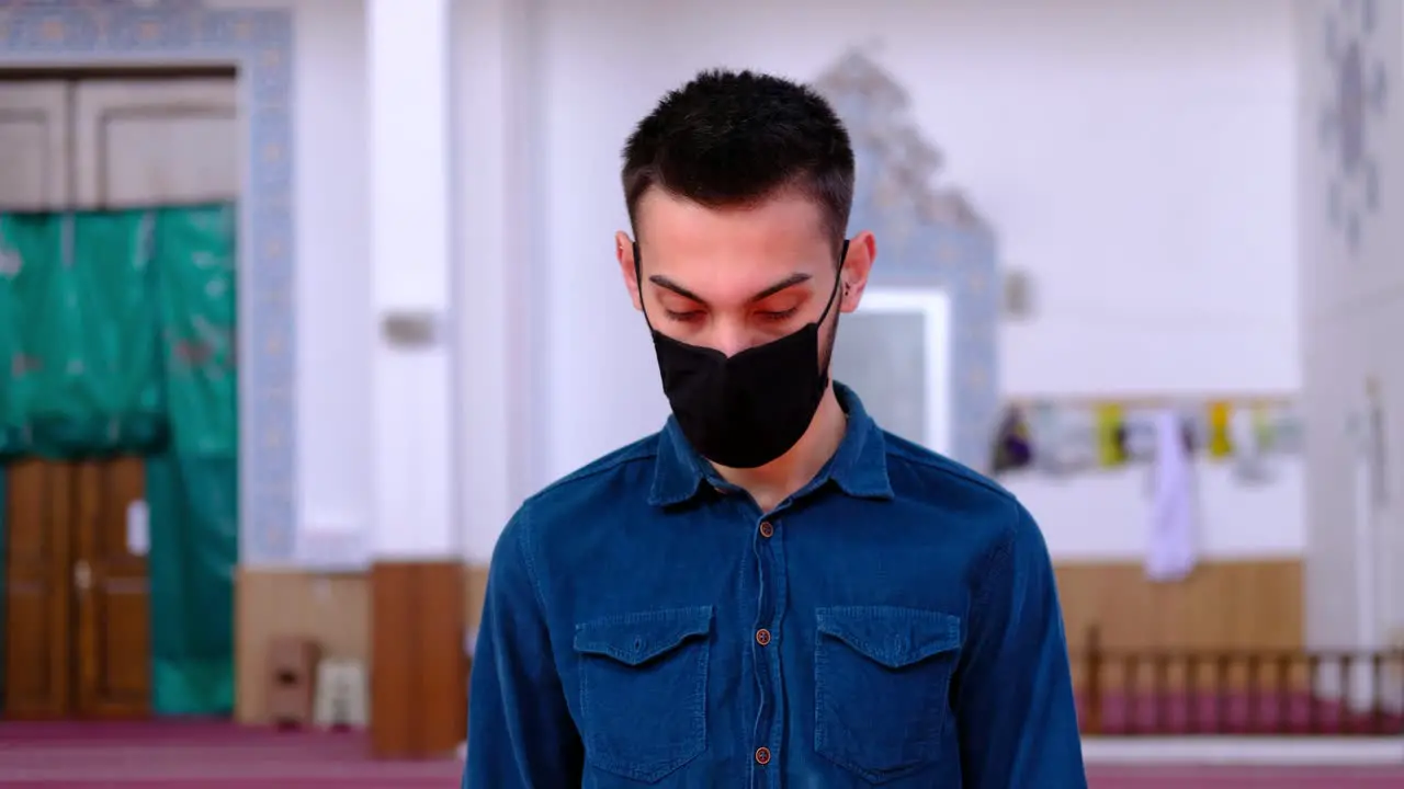 Man Worships in A Mask During Pandemic