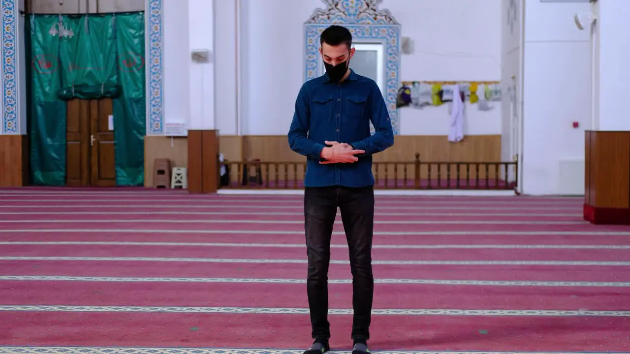 Young Man With Mask Worships In Mosque