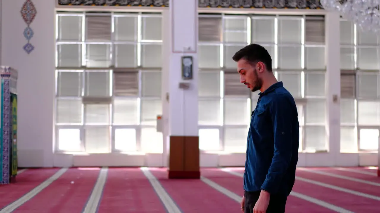 Young Man Prays and Worships In Mosque