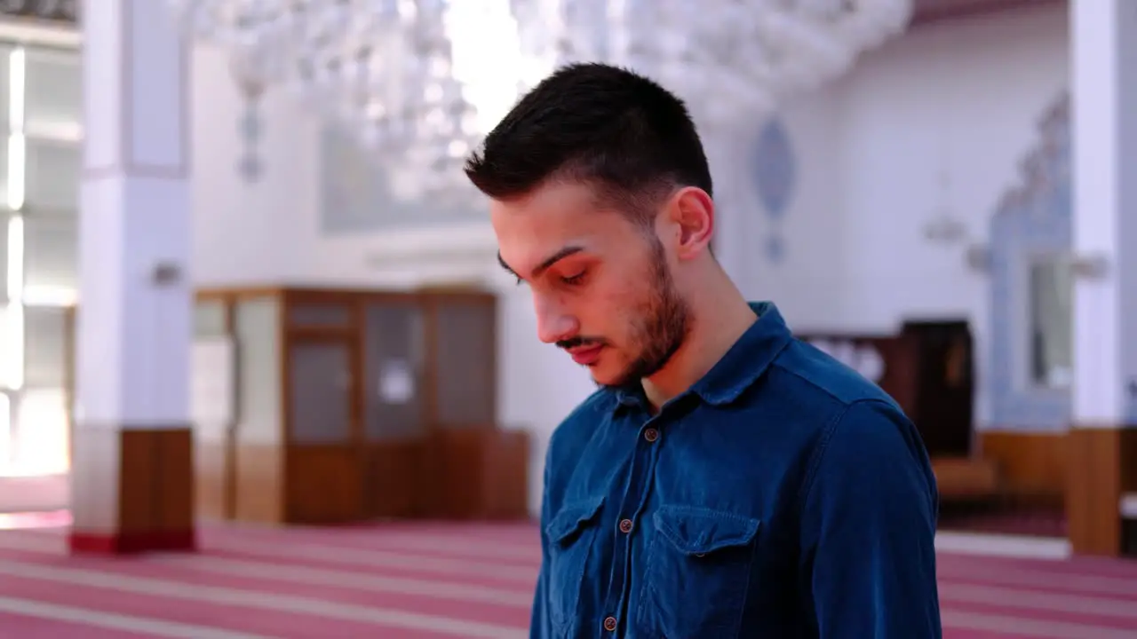 Young Man Prays in Sunny Mosque