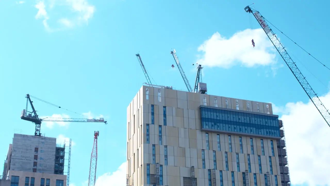 Low angle shot of cranes and construction on top of building Woking Surrey