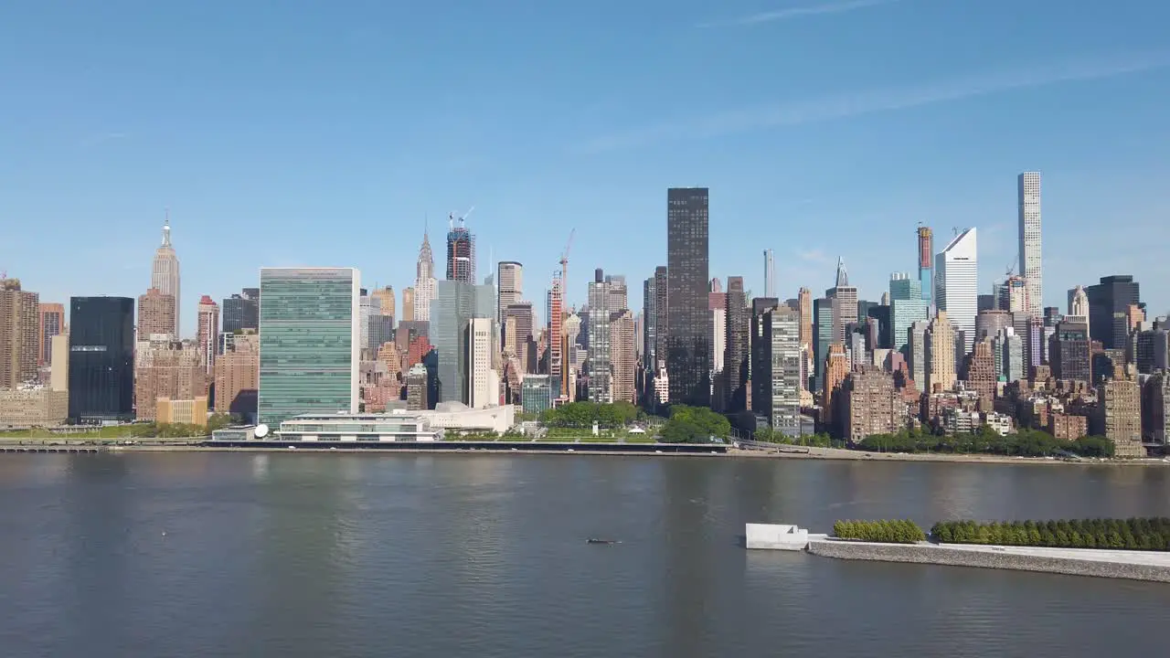 Panning shot of East Side Manhattan filmed from Long Island City on a sunny summer day