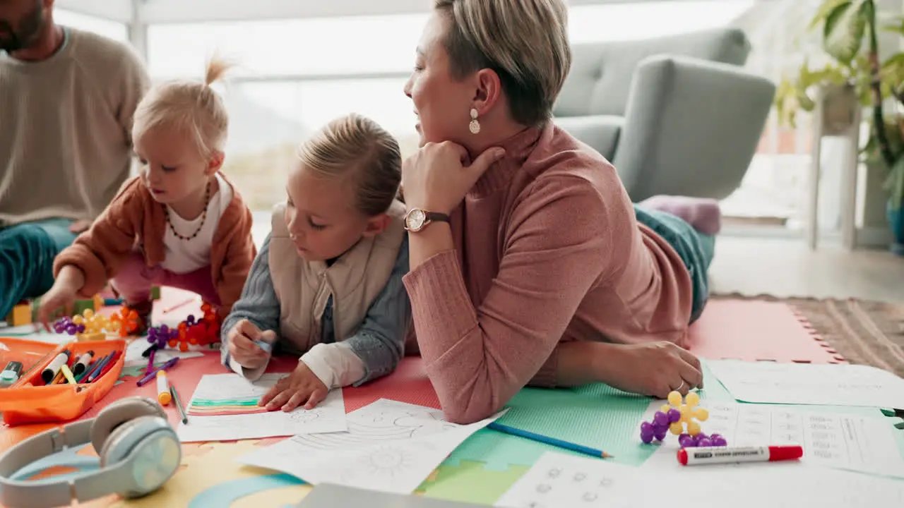 Parents children and drawing on floor in family