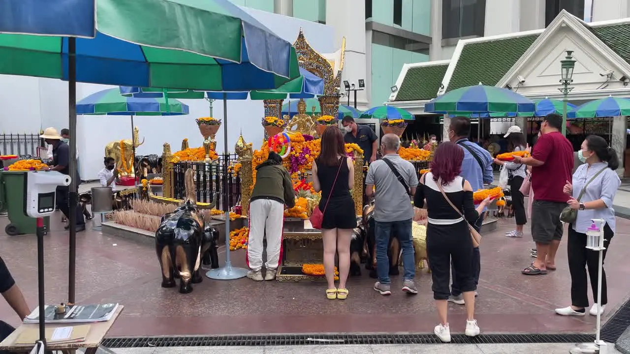 Visitors praying at Four-Faced Buddha  Erawan Shrine Bangkok