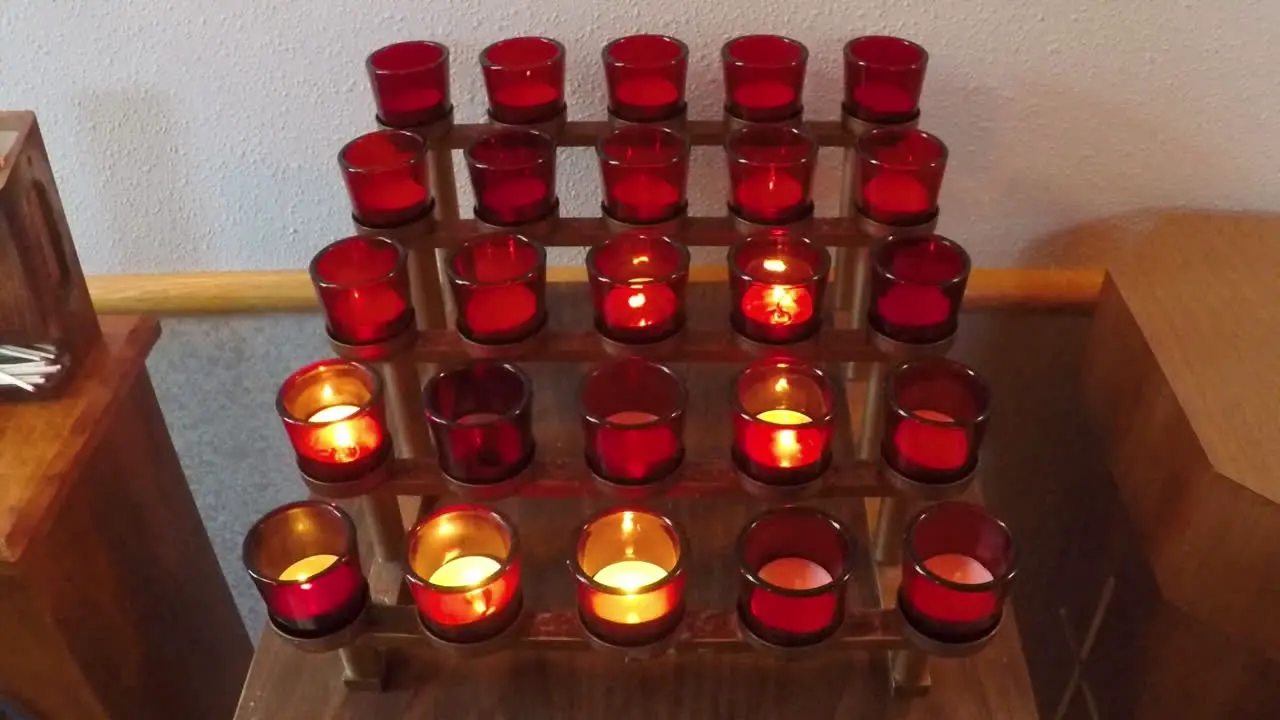 A large group of religious votive candles at a Catholic church