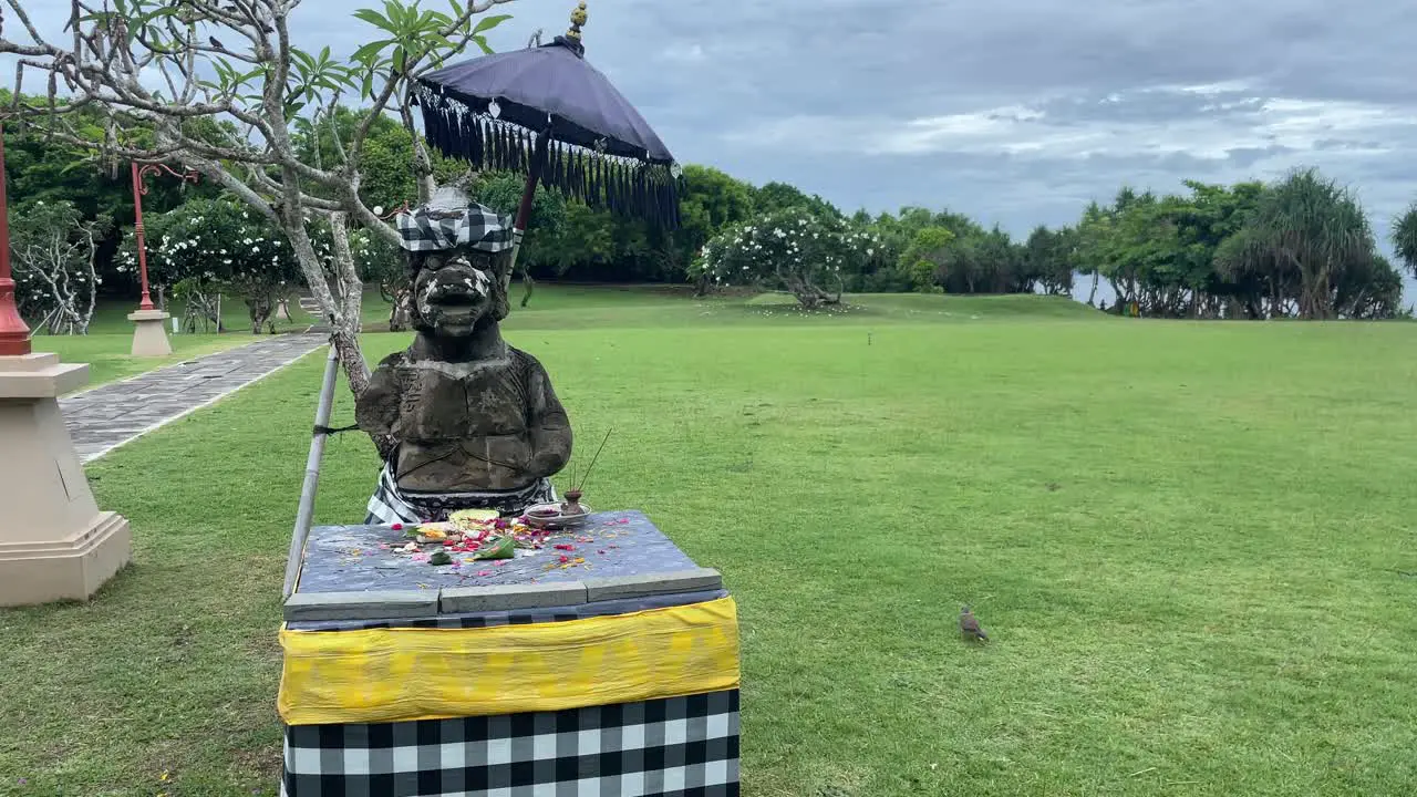 Lush green park with hindu God statue flowers and food as sacrifice offering