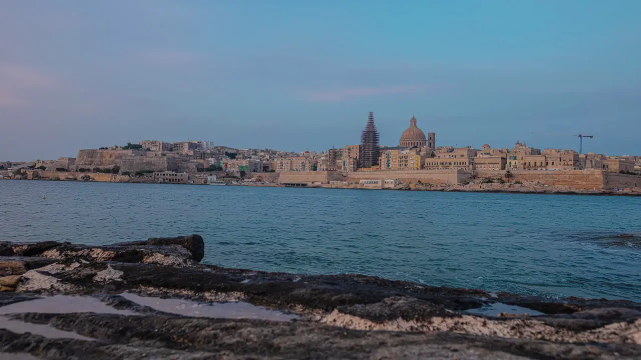 A Time Lapse Shot Of A Coastal Cityscape From Twilight With Bright City Lights To Dawn