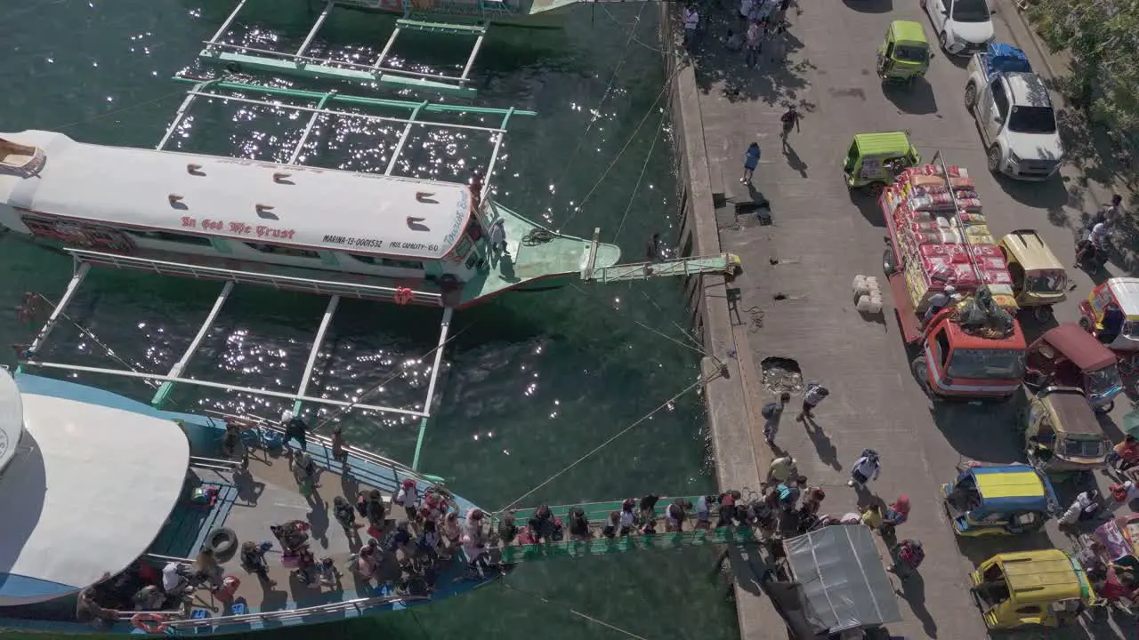 Groups of island hopping tourists disembark from passenger ferries at Surigao Boulevard