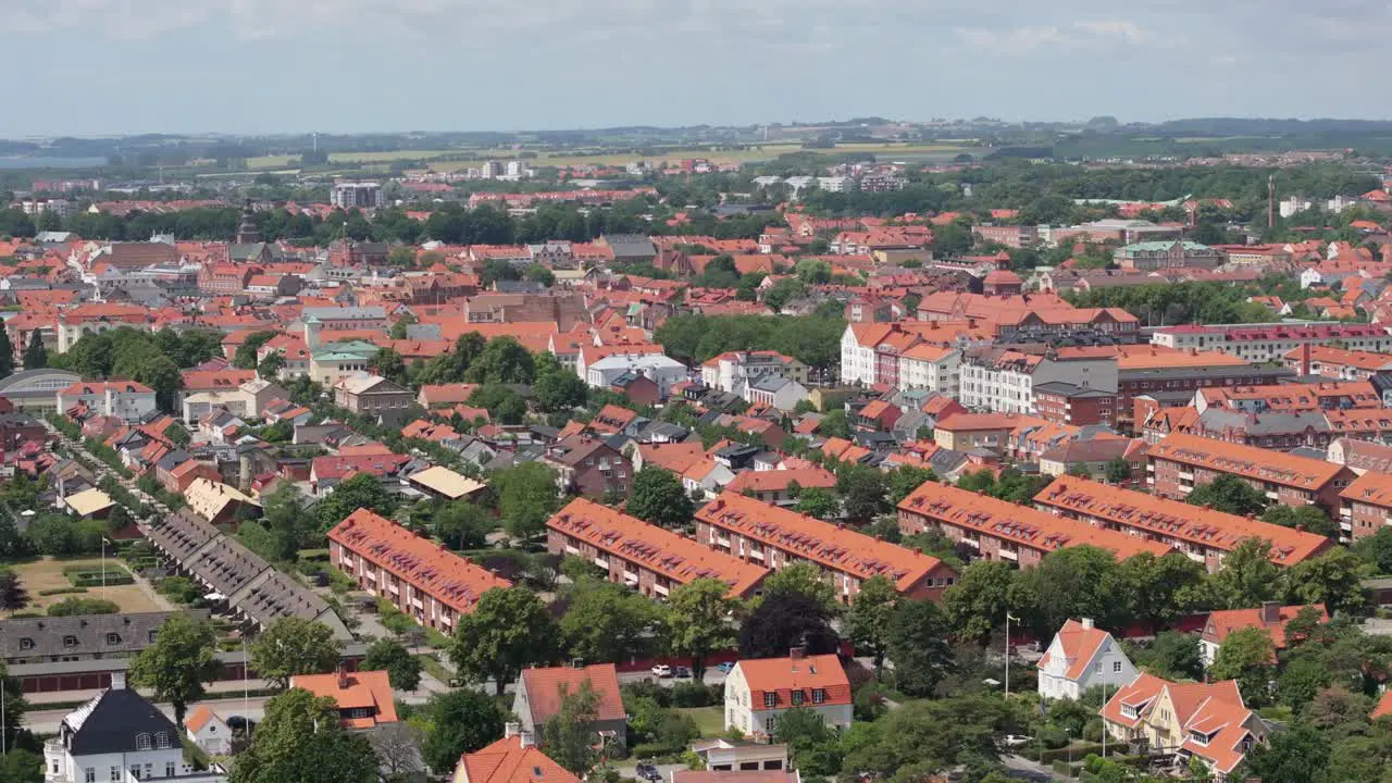 Skyline of Swedish city Ystad on a sunny summer day aerial telephoto orbit