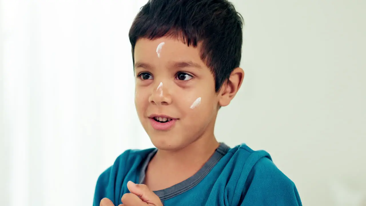 Young boy skincare laugh and lotion with a smile