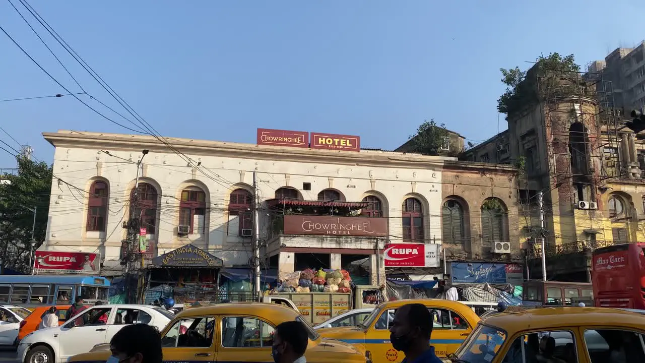 Famous Indian city road landmark Chowringhee hotel at Dharamtala crossing Kolkata with Metropolitan colonial heritage building