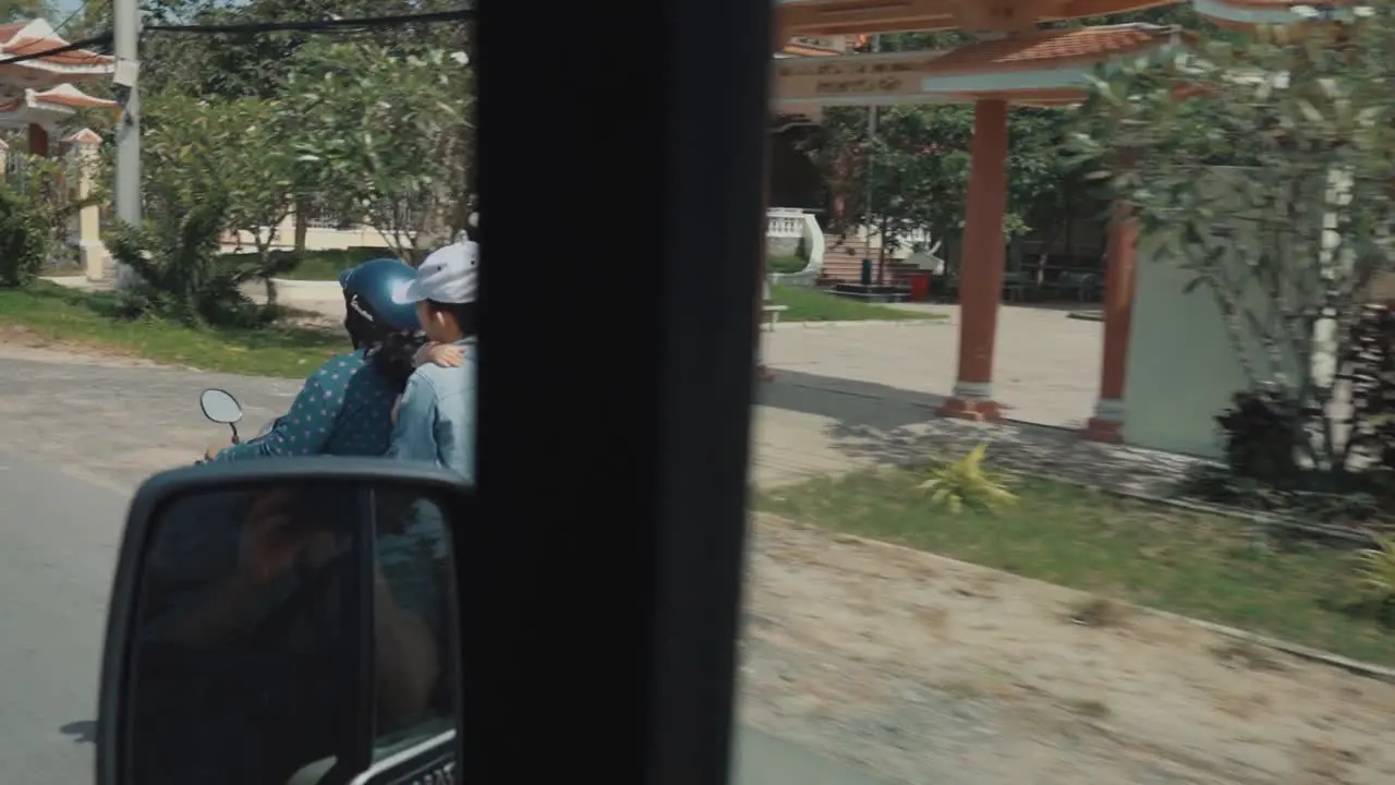 Vietnamese Family Riding through the City on a Moped